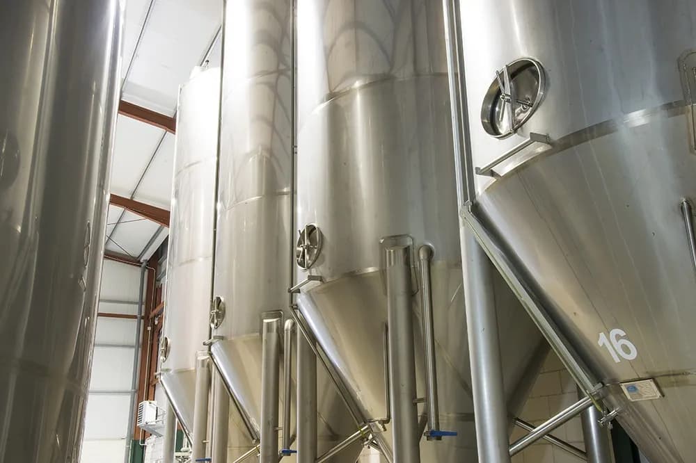 Stainless-steel decanting tanks inside the olive mill